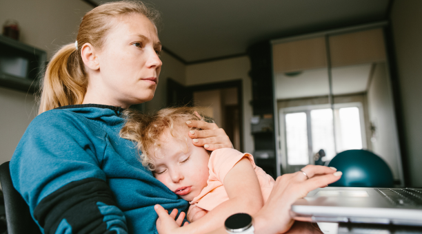 Mother cares for child while working